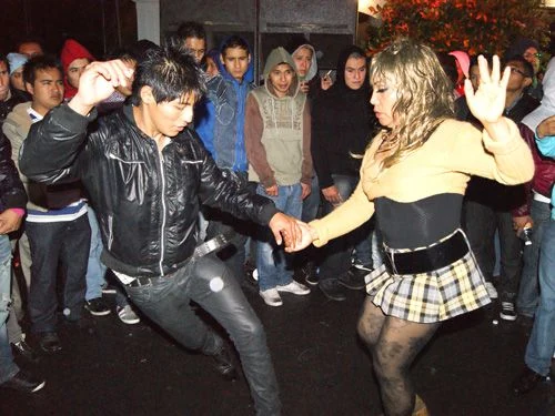 People dancing at a nighttime sonidero gathering